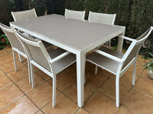 Load image into Gallery viewer, 1019 - Aluminum outdoor table (152cm x 90cm) + 6 chairs. It is in good condition, the "scratches" on the top are reflection.
