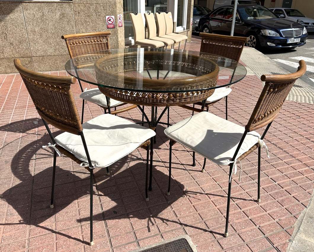 1056 - Round glass/rattan table (110cm across) + 4 chairs + cushions in good condition!