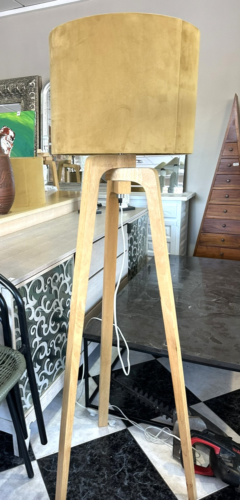 1094 - Light wooden tripod lamp (151cm) with mustard colored lamp shade. THEY ARE IN GOOD CONDITION BUT LOOKS TERRIBLE ON THE PHOTO DUE TO THE LAMP SHADES ARE VELVET.  WE HAVE TWO IN STOCK!)